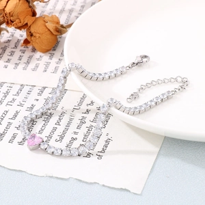 Detail of pink heart crystal bracelet with square zirconia accents and adjustable chain