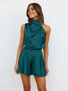Detail of elegant dark green satin halter romper with draped cowl neck and silk texture