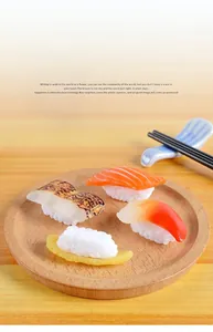 Detailed view of four realistic PVC sushi models on a round wooden serving tray