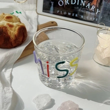 Detail of high borosilicate glass featuring colorful cursive miss text and ice cubes