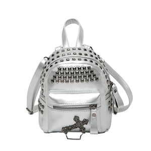 Silver punk mini backpack with metallic studs and cross pendant on white background
