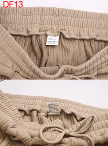 Detail view of khaki ribbed pants showing elastic waist drawstring and size labels