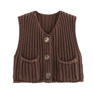 Detail of chunky knit V-neck vest in brown with retro textured buttons and patch pockets