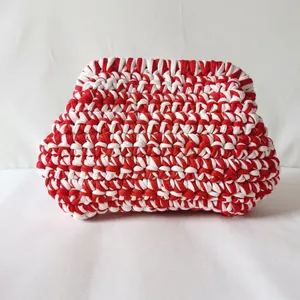 Detail of red and white striped hand-woven crochet bag with premium cotton fabric texture