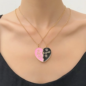 Gold split heart pendant necklace with pink and black Best Friends enamel detail