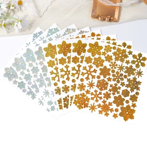 Detail of gold and holographic silver laser glitter snowflake stickers for DIY gift decor