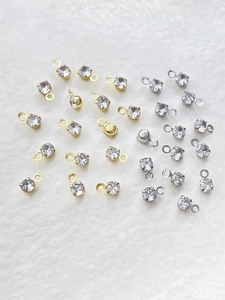 Close-up of gold and silver plated cubic zirconia charms for DIY jewelry making