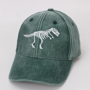Detail shot of green washed cotton baseball cap with white dinosaur skeleton embroidery