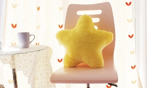 Cozy yellow star-shaped plush pillow on a stylish chair in a bright, modern living room