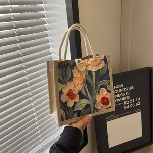 Artistic floral print burlap tote bag with cotton rope handle and wooden button detail