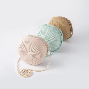Set of three round woven straw cross-body bags for girls in beige, green, and khaki