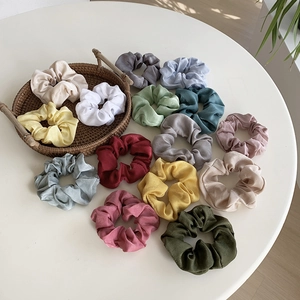 Set of 14 colorful satin scrunchies in soft Morandi tones for elegant hair styling