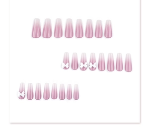 Macro detail of long coffin nails with soft pink ombre and 3D white bow accents