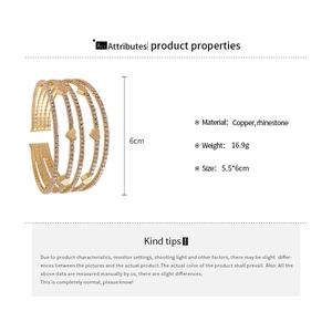 Detail view of gold multi-layer rhinestone heart cuff bracelet with size and weight specs