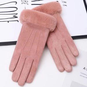 Close-up of pink suede winter gloves with plush cuffs and touch screen fingers