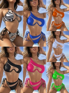 Detail of cut-out one-shoulder bikini top with mesh patchwork and side-tie bottom
