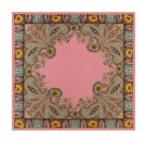 Detail of pink paisley silk scarf featuring intricate bohemian patterns and smooth satin texture