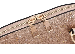 Detail of metal dual zippers and shiny star sequins on the golden handbag surface