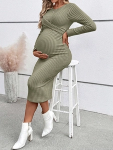 Detail of sage green maternity dress showing ribbed knit texture and side-tie knot design