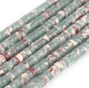 Macro shot of cylindrical natural stone beads in green and reddish brown for DIY jewelry