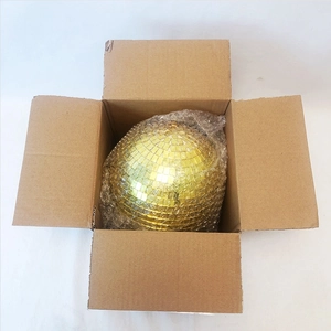 Golden disco ball with reflective mirror tiles inside a shipping box with bubble wrap