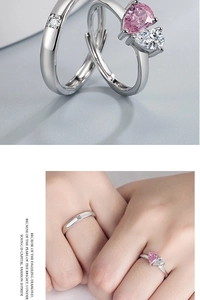 Macro shot of silver couples rings featuring pink pear-shaped stone and square zircon