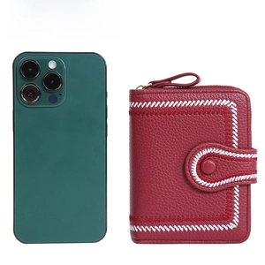 Baellerry red short wallet with litchi texture and embroidery next to smartphone