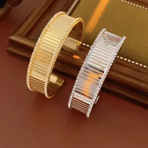 Luxurious gold and silver plated open bangles with striped texture and pavé rhinestones