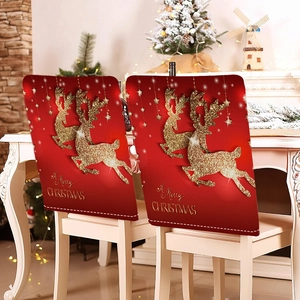 Detail of red Christmas chair covers with gold glitter reindeer and festive text decor