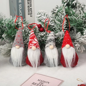 Set of four red and grey knitted Christmas gnome ornaments with hanging strings and faux beards