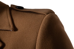 Close-up of brown wool coat shoulder showing twill texture and dark resin button detail