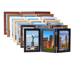 Detail of multi-fold wooden photo frames showing metallic hinges and various finishes