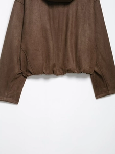 Close-up of the elastic hem and premium brown faux suede texture on the bomber jacket
