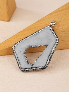 Detail of irregular geode crystal pendant with sparkling rhinestone edge and metal hook