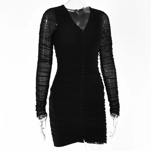 Close-up of black bodycon dress featuring V-neckline, long sleeves, and ruched details
