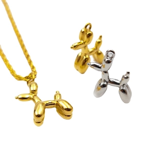Minimalist 18K gold and silver balloon dog pendants with a glossy metallic finish