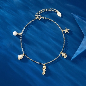 Macro shot of S925 sterling silver tag and gold-plated ocean charms with water ripple lighting