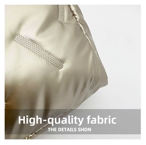 Close-up of champagne gold quilted fabric with soft metallic texture and stripe detail