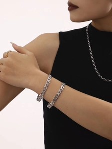 Polished silver hollow heart chain bracelets worn with stylish accessories