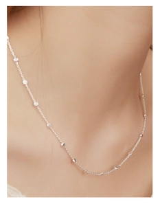 Detailed close-up of 925 sterling silver chain necklace with mini round disc pendants