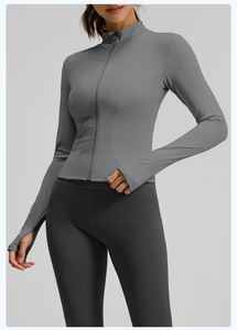 Close-up of gray slim fit sports jacket with standing collar and functional thumbholes