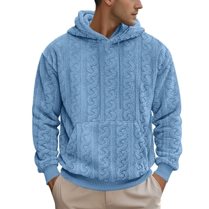 Detail of light blue sherpa fleece texture on men's hooded sweatshirt with cable knit pattern