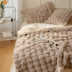 Detail of luxury beige faux fur blanket with thick 3D wave bubble texture for winter