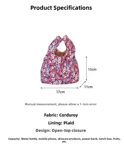 Detail view of floral corduroy wrist bag with dimensions 17x15x11cm and plaid lining