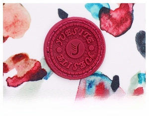 Detailed close-up of YUESITE brand logo on floral nylon fabric with fine stitching