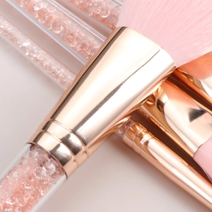Detail of pink makeup brushes with gold ferrule and crystal filled clear handles