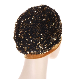 Fashion turban hat with gold sequins and black velvet fabric shown from side view