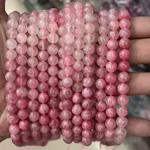 Macro shot of multiple high-quality natural pink crystal round beads for DIY jewelry