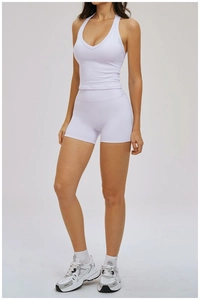 Detailed front view of white yoga set featuring V-neck tank top and high-waist biker shorts