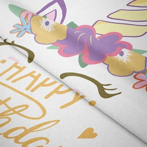 Detail of soft microfiber velvet tapestry featuring unicorn happy birthday pattern
